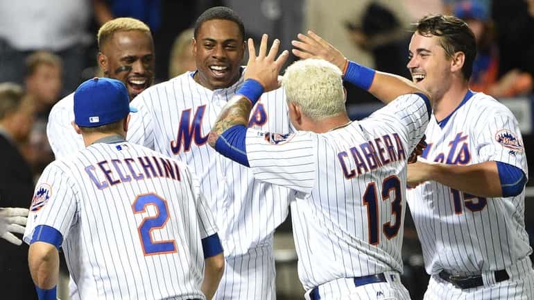 The New York Mets celebrate the walk-off home run by...