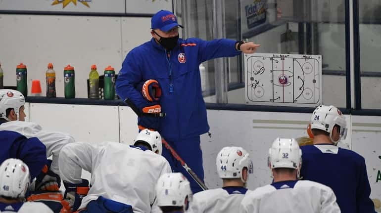 Islanders head coach Barry Trotz directs his players during Training...