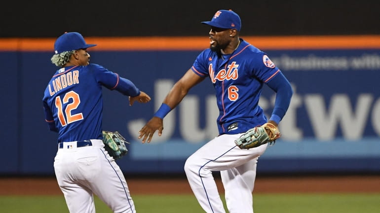 Mets' Francisco Lindor and Starling Marte celebrate their 10-0 win...