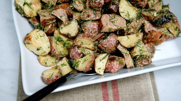 Grilled kielbasa and potato salad, prepared with scallions and a...
