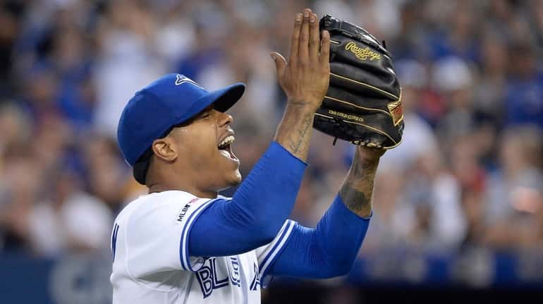 Blue Jays starting pitcher Marcus Stroman reacts as he walks...