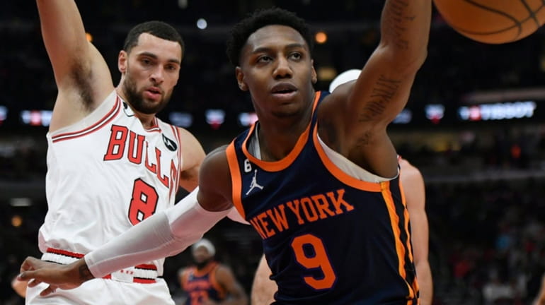 The Knicks' RJ Barrett battles the Bulls' Zach LaVine for the...