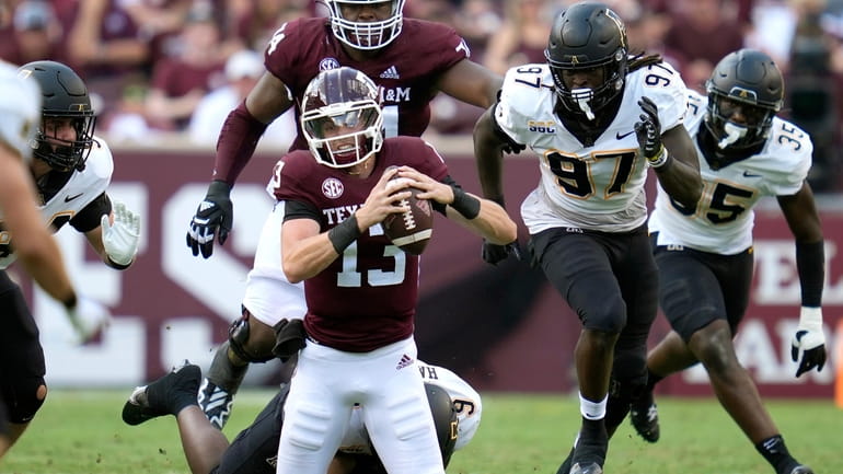 Texas A&M quarterback Haynes King (13) is tackled for no...
