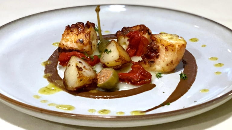 Octopus with potatoes, tomato confit and caper berries at Edoardo's...