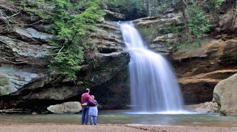 Visitors experience breathtaking Cedar Falls in Hocking Hills, Ohio.
