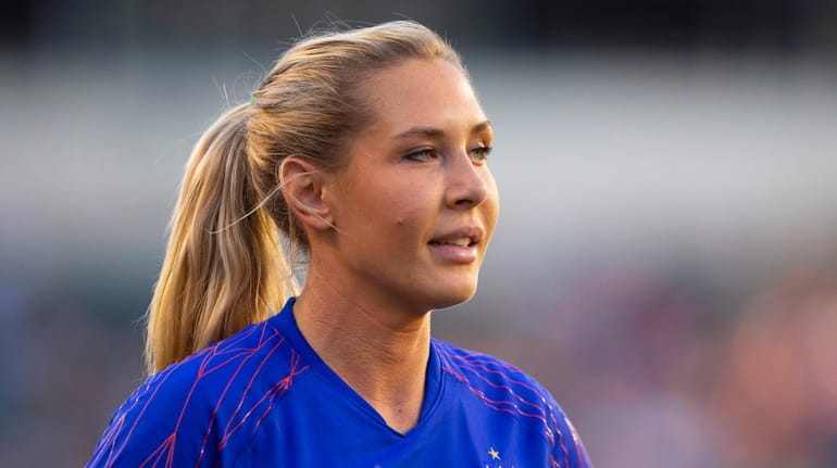 Allie Long #20 of the United States walks off the...