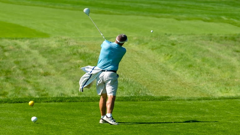 A golfer tees off at Bethpage Golf Course.