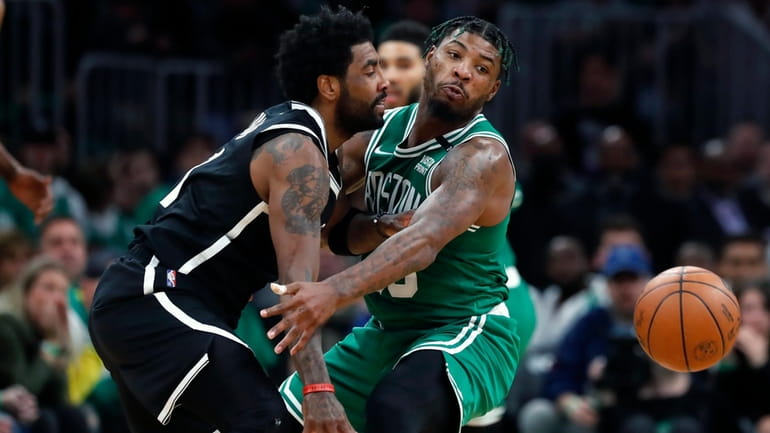 Boston Celtics' Marcus Smart, right, defends against Brooklyn Nets' Kyrie...