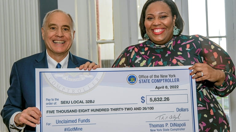 New York State comptroller Thomas DiNapoli delivering an oversized check for...