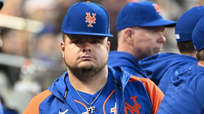 New York Mets' Daniel Vogelbach looks on from the dugout...