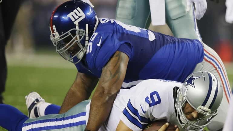 Cullen Jenkins sacks Dallas Cowboys quarterback Tony Romo during the...
