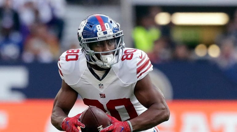Giants wide receiver Victor Cruz runs after a catch during...
