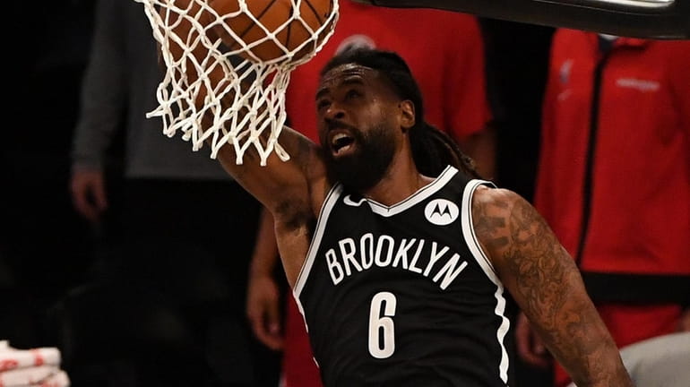 Nets center DeAndre Jordan sinks a reverse dunk against the...