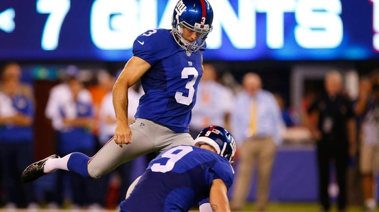 Josh Brown of the New York Giants kicks a field...