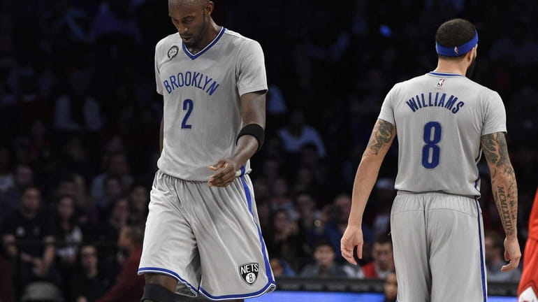 Brooklyn Nets forward Kevin Garnett and guard Deron Williams look...