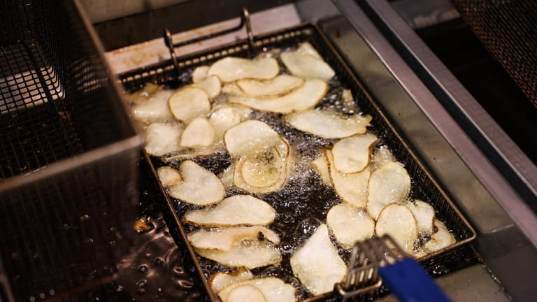 Potato chips fry in oil at Barona Bay in Hampton Bays.