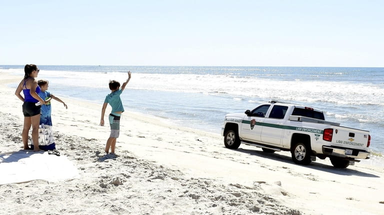 Landon Hershey, 11, waves to a Suffolk County park ranger...