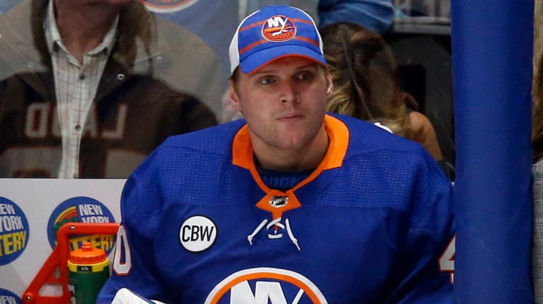 Robin Lehner of the Islanders looks on from the bench...