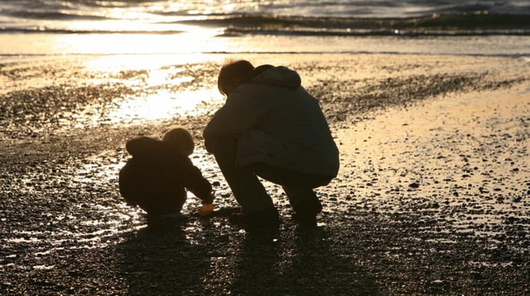 A parent and child at the beach.