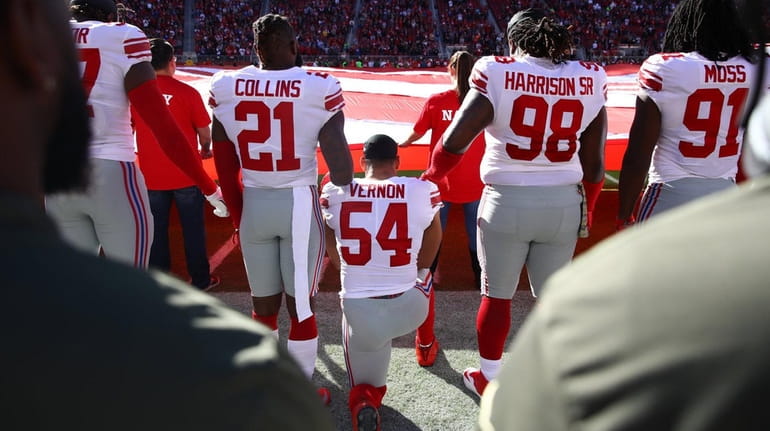 Giants defensive end Olivier Vernon kneels during the national anthem...