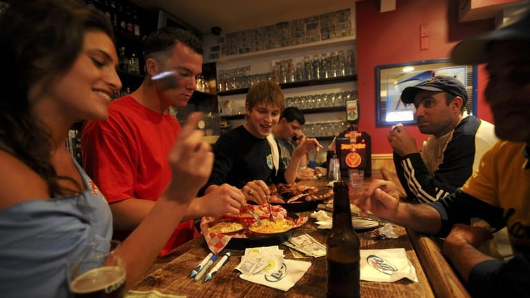 Diners attempting to eat "The Challenge" at Swingbellys in Long...