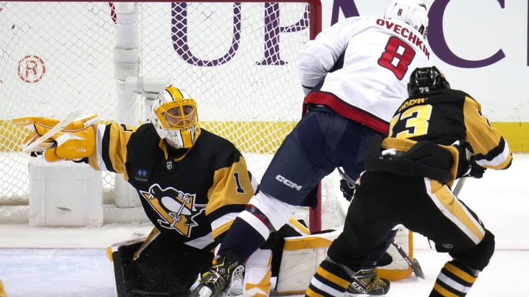 Pittsburgh Penguins goaltender Casey DeSmith (1) stops a breakaway shot...