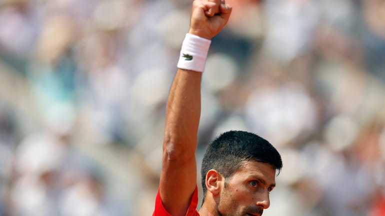 Serbia's Novak Djokovic reacts after winning the fourth game of...