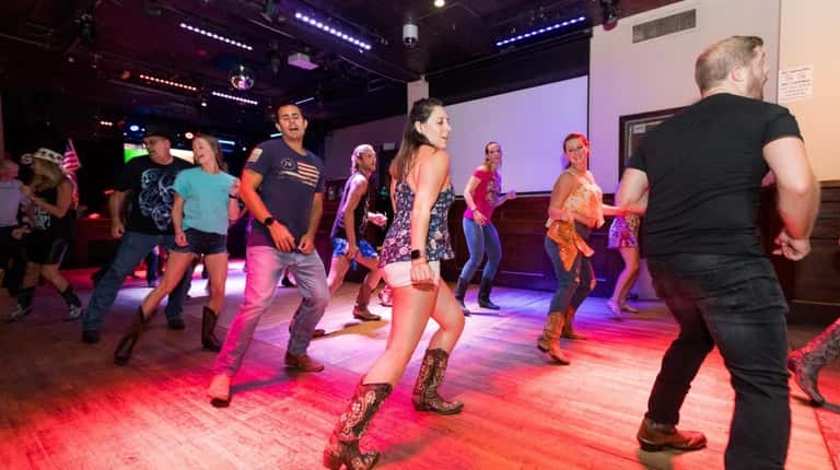 Brianna Sanzotta, of Holbrook, 31, second from right, line dances...