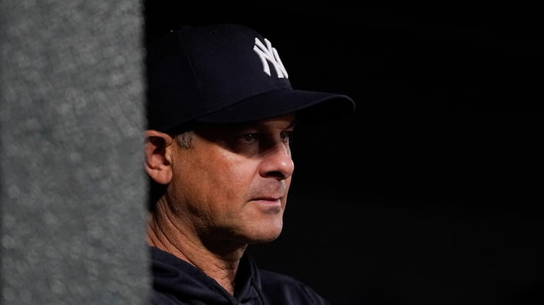 Yankees manager Aaron Boone looks on from the dugout during...