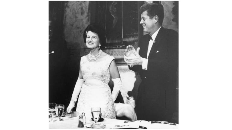 Rose Fitzgerald Kennedy with her son then-President John F. Kennedy as he applauds...