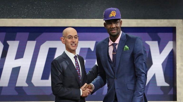 Arizona's Deandre Ayton poses with NBA Commissioner Adam Silver after...