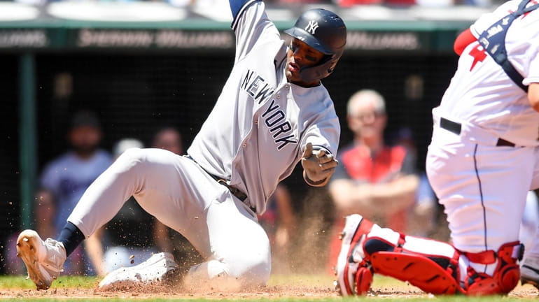 Miguel Andújar of the New York Yankees scores on a two-run...