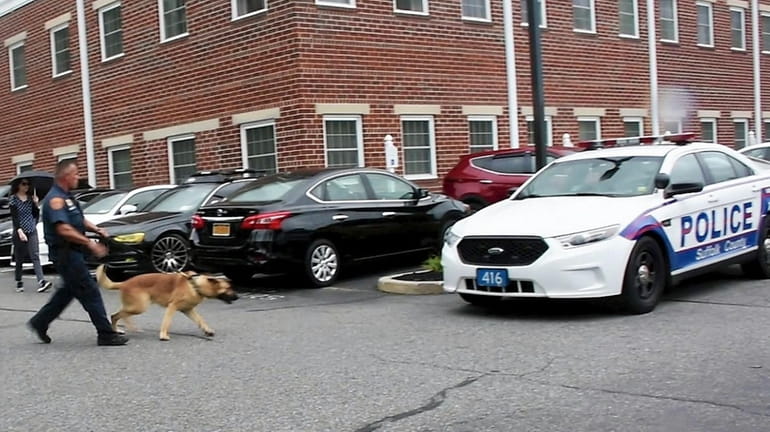 Suffolk police's K-9 unit responds to the scene Wednesday after...