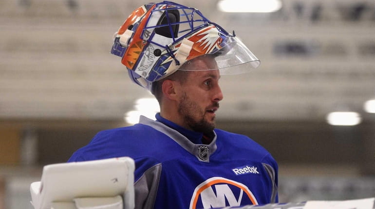 New York Islanders goalie Jaroslav Halak looks on during training...