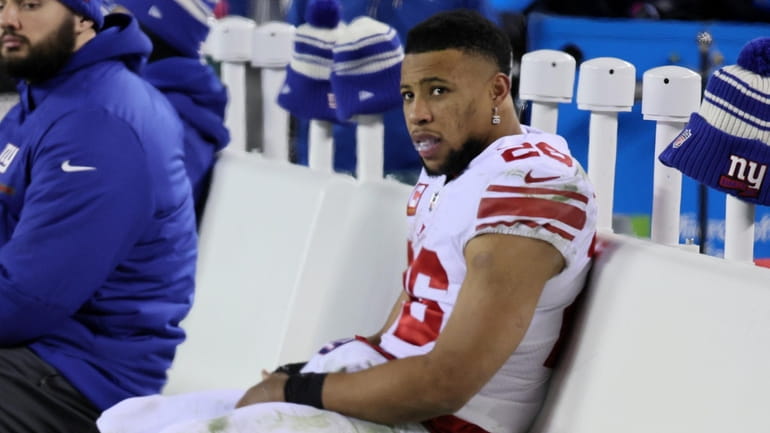 Giants running back Saquon Barkley on the bench near the end...
