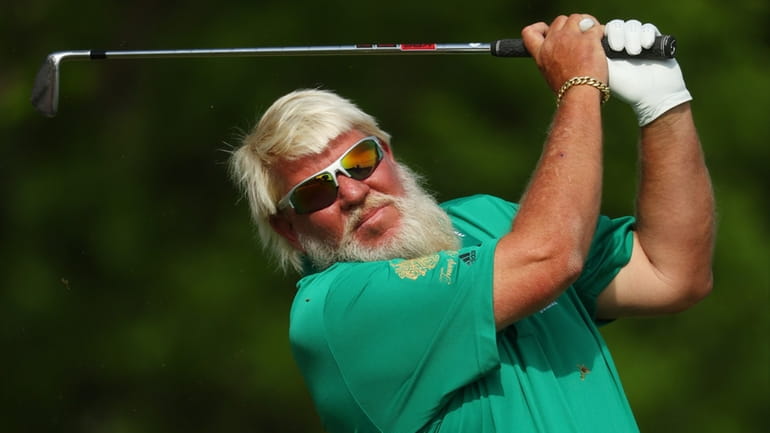 John Daly plays his shot from the 11th tee during...