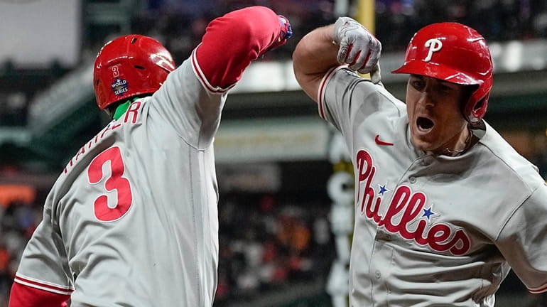 Philadelphia Phillies' J.T. Realmuto, right, celebrates his solo homer with...