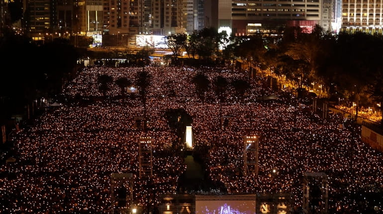 Thousands of people attend a candlelight vigil for victims of...