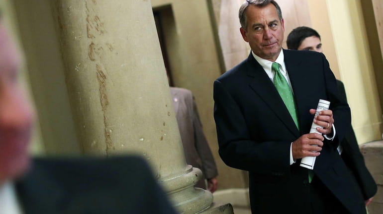 Speaker of the House John Boehner walks to the House...