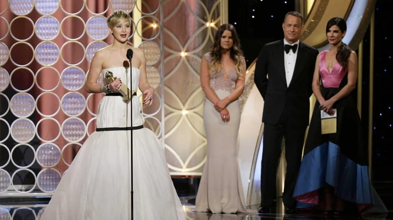 Jennifer Lawrence, left, accepting the award for best supporting actress...