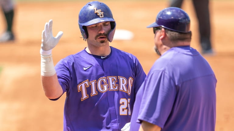LSU's Hayden Travinski, left, reacts at the plate during an...