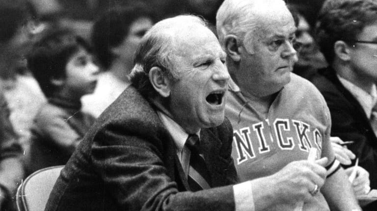 Red Holzman coach of the Knicks yells out instructions to...