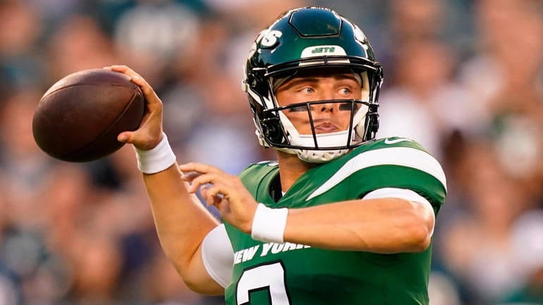 New York Jets' Zach Wilson throws during the first half...