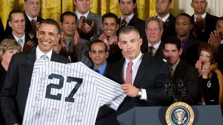 New York Yankees manager Joe Girardi presents President Barack Obama...