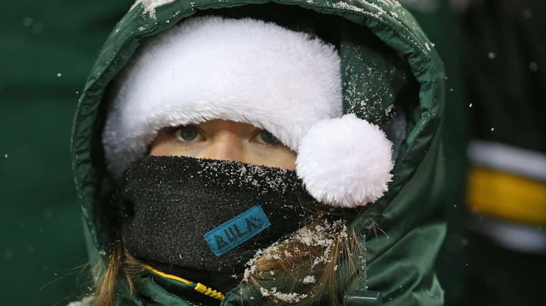 A fan of the Green Bay Packers tries to stay...