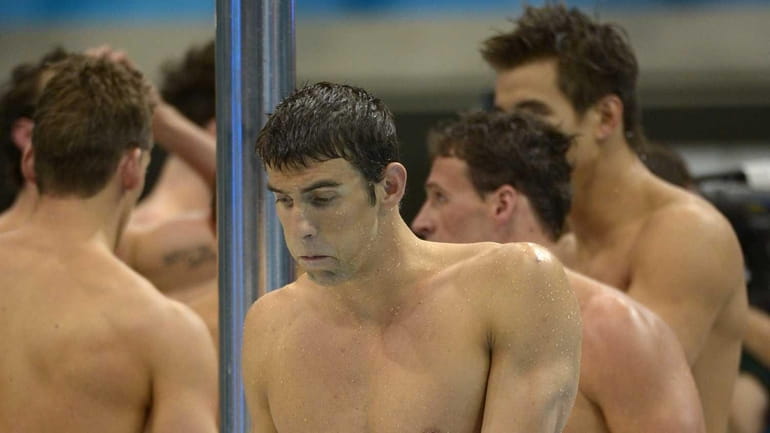 Michael Phelps reacts after his team won silver in the...