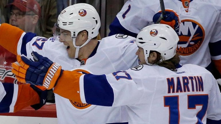 New York Islanders defenseman Thomas Hickey (14) celebrates his game-winning...
