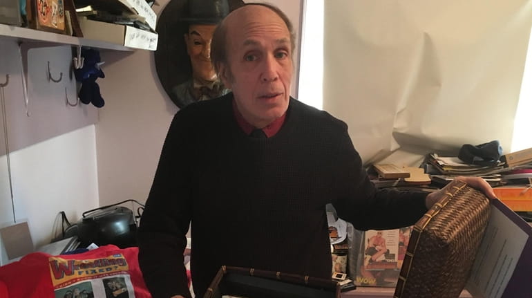 Pro wrestling journalist Bill Apter holds cassettes of classic interviews...