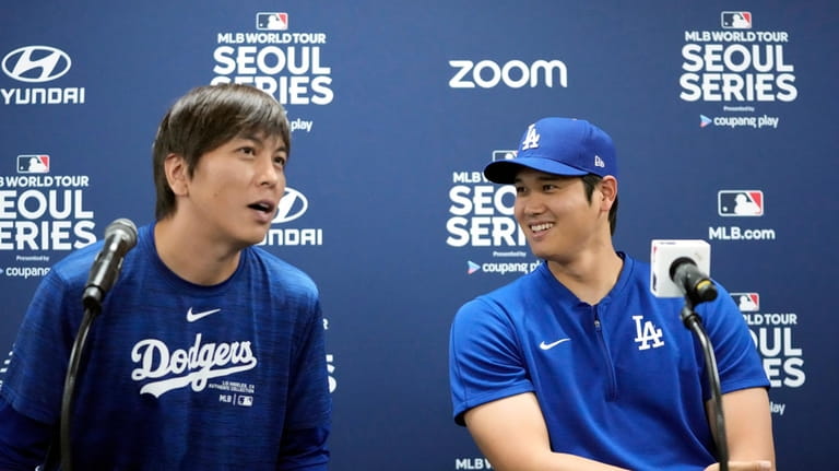 Los Angeles Dodgers' Shohei Ohtani, right, and his interpreter, Ippei...