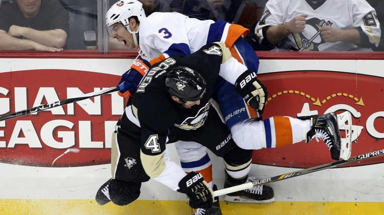 Pittsburgh Penguins' Rob Scuderi collides with New York Islanders' Travis...